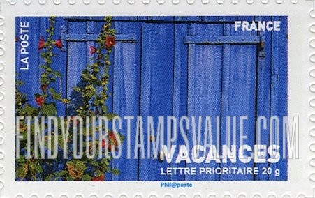 FindYourStampsValue: Vacations: Wooden fence and red hollyhocks